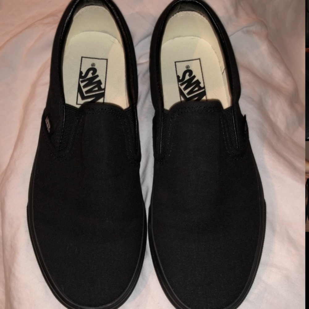 All black slip-on Vans